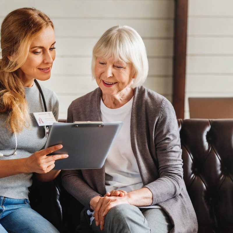 front-view-shot-of-caring-young-woman-nurse-help-old-granny-during-homecare-medical-visit.jpg
